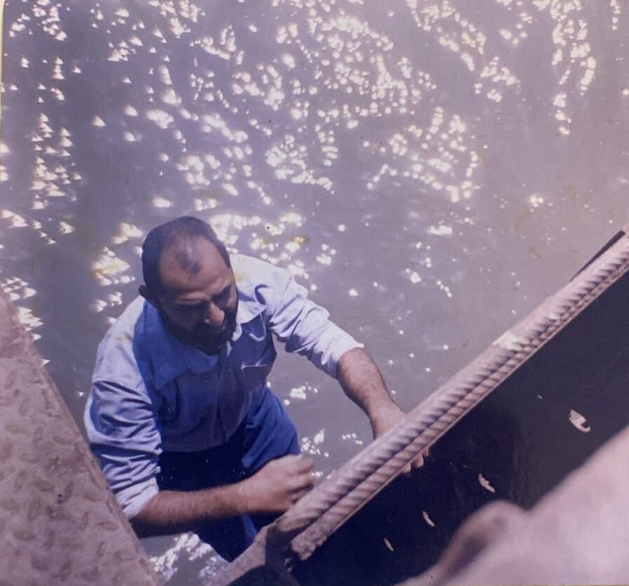 Atlanta Waterproofing's founder inspecting reinforcement at a marine structure above open water.